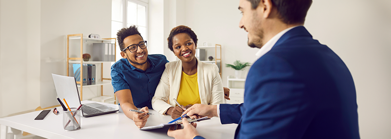 Couple working with Loan Officer in office