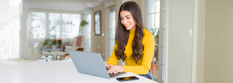 Smiling woman looking at laptop