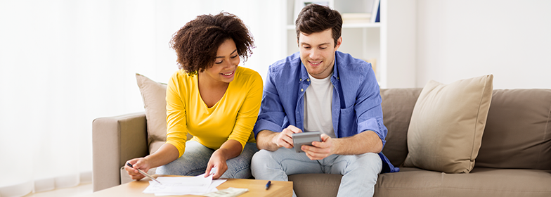 Couple looking at finances on the couch