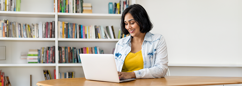 Smiling woman looking at laptop